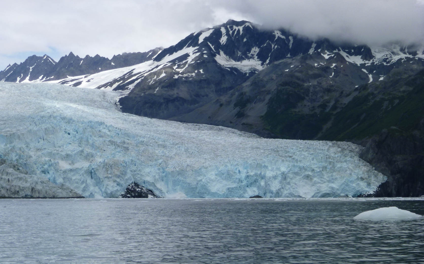 The face of Aialik Glacier, with small icebergs in the foreground