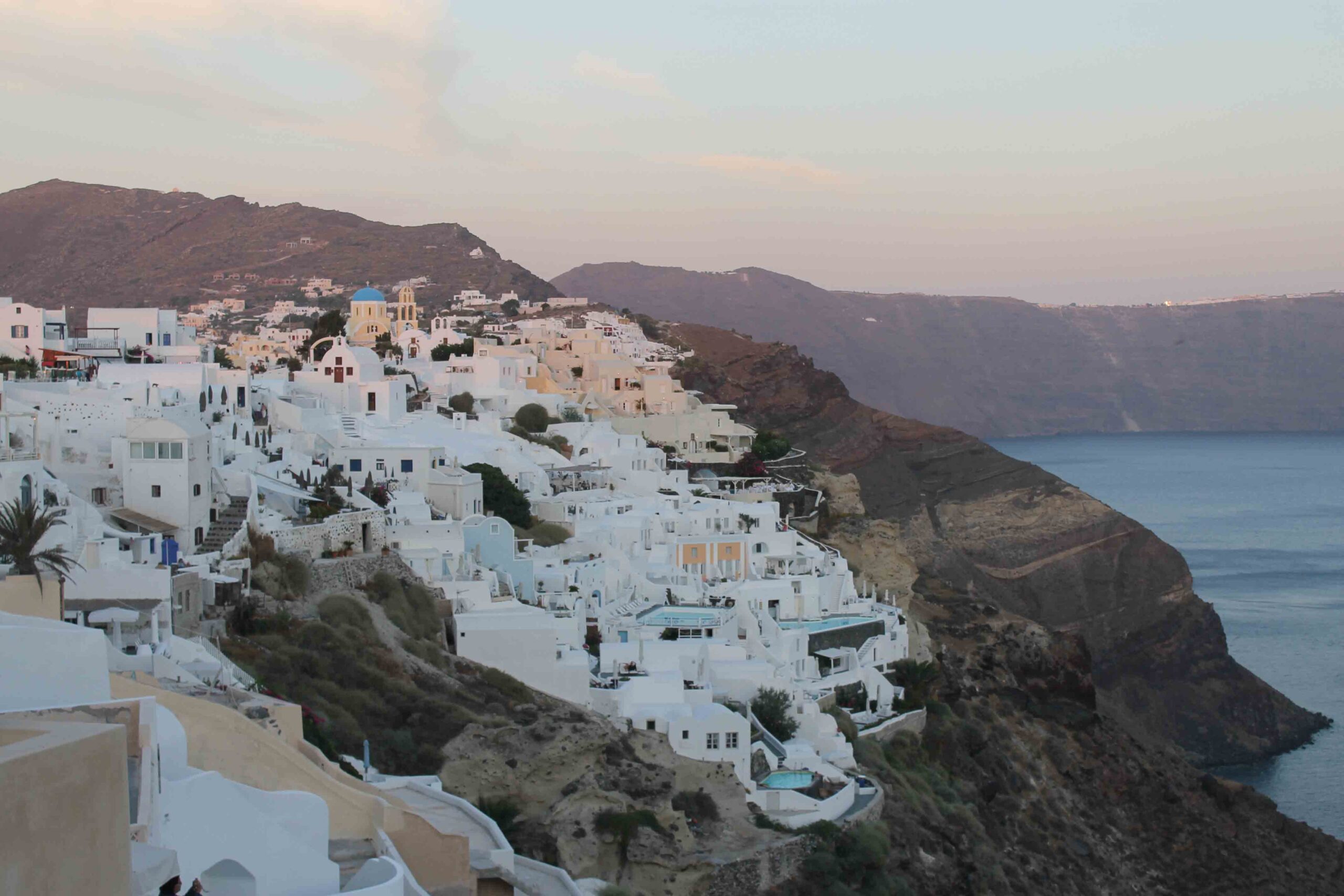 Sunset view of Oia and the Santorini coastline