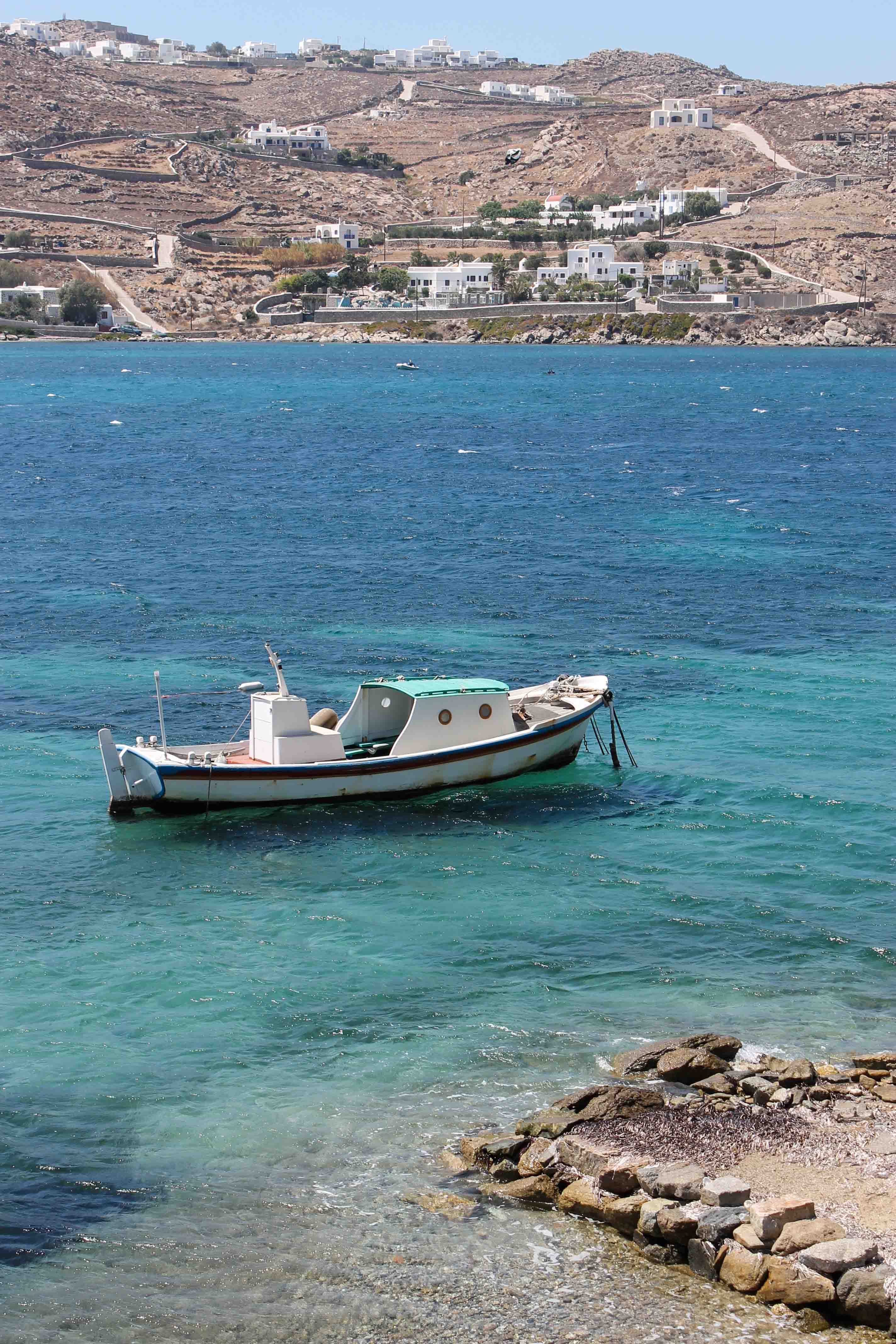 A boat and coastal views while walking from Ornos to Chora on Mykonos