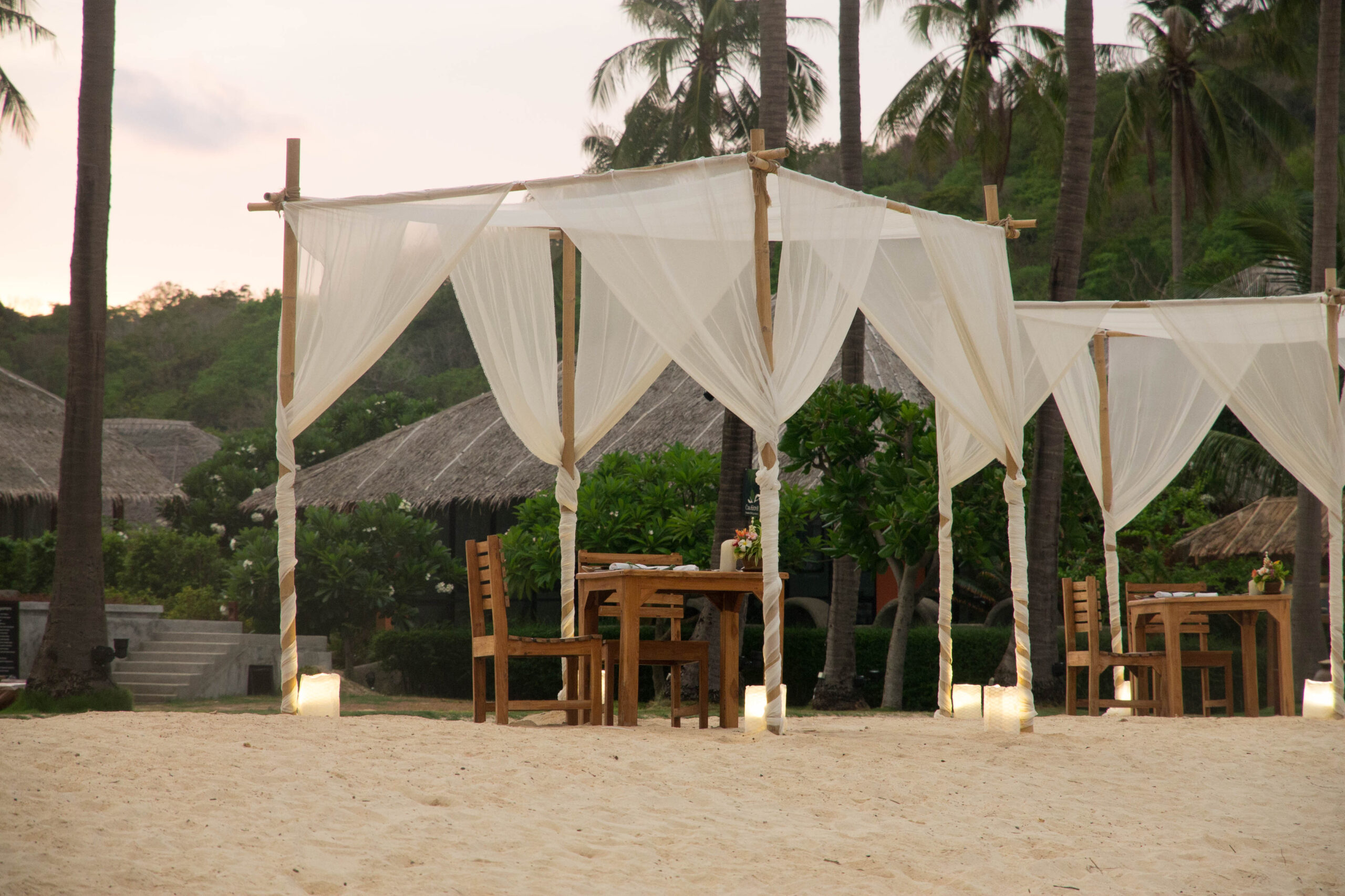 Cabanas set up for a beachfront dinner at SAii Phi Phi Island Village