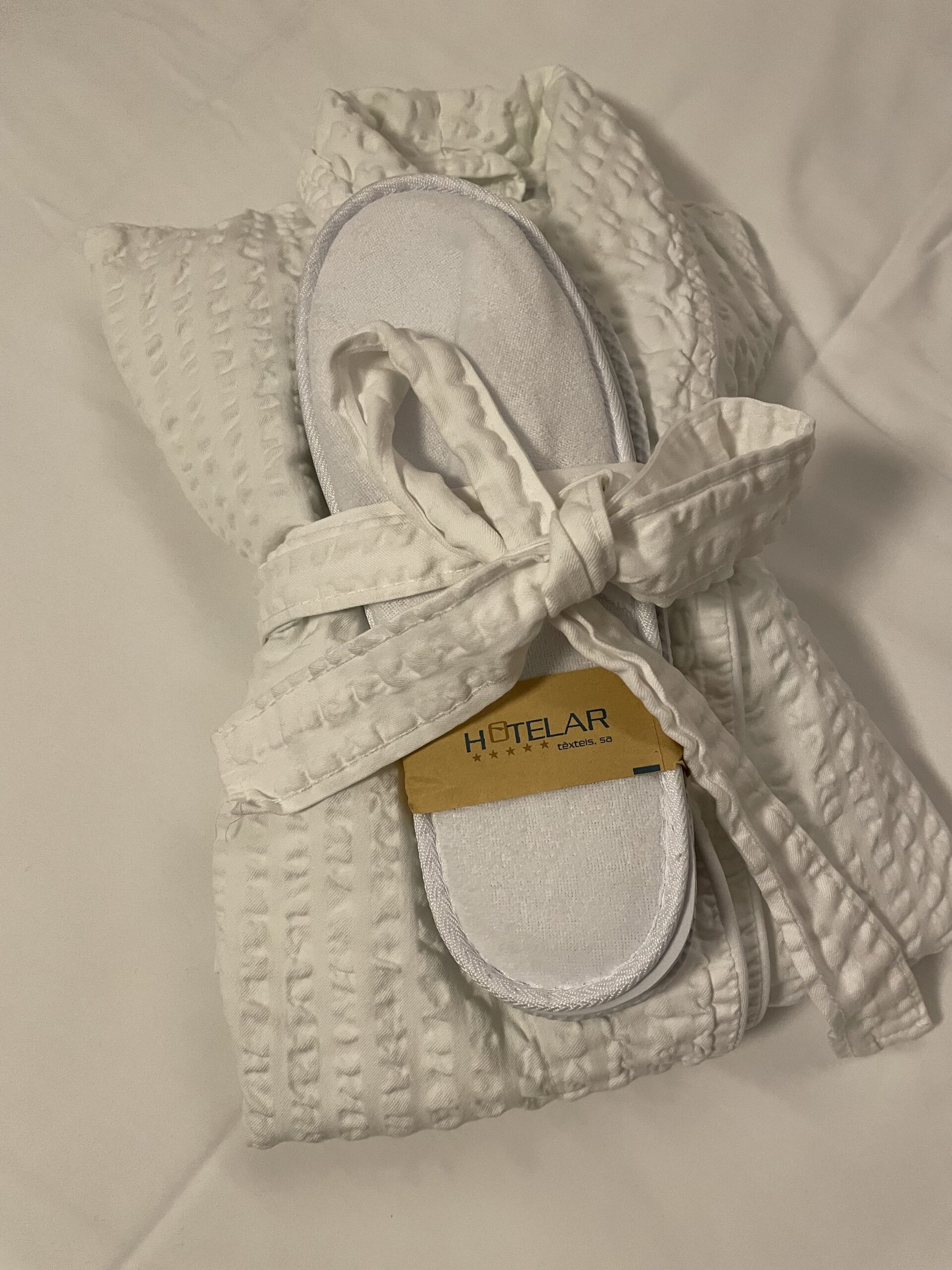 Bathroom and slippers in our room at Hotel Amadeus