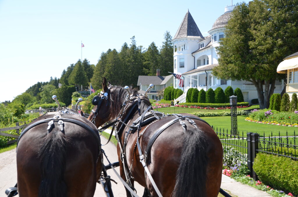 Riding in a horse drawn carriage on Mackinac Island, one of the ways to get around this car-free island